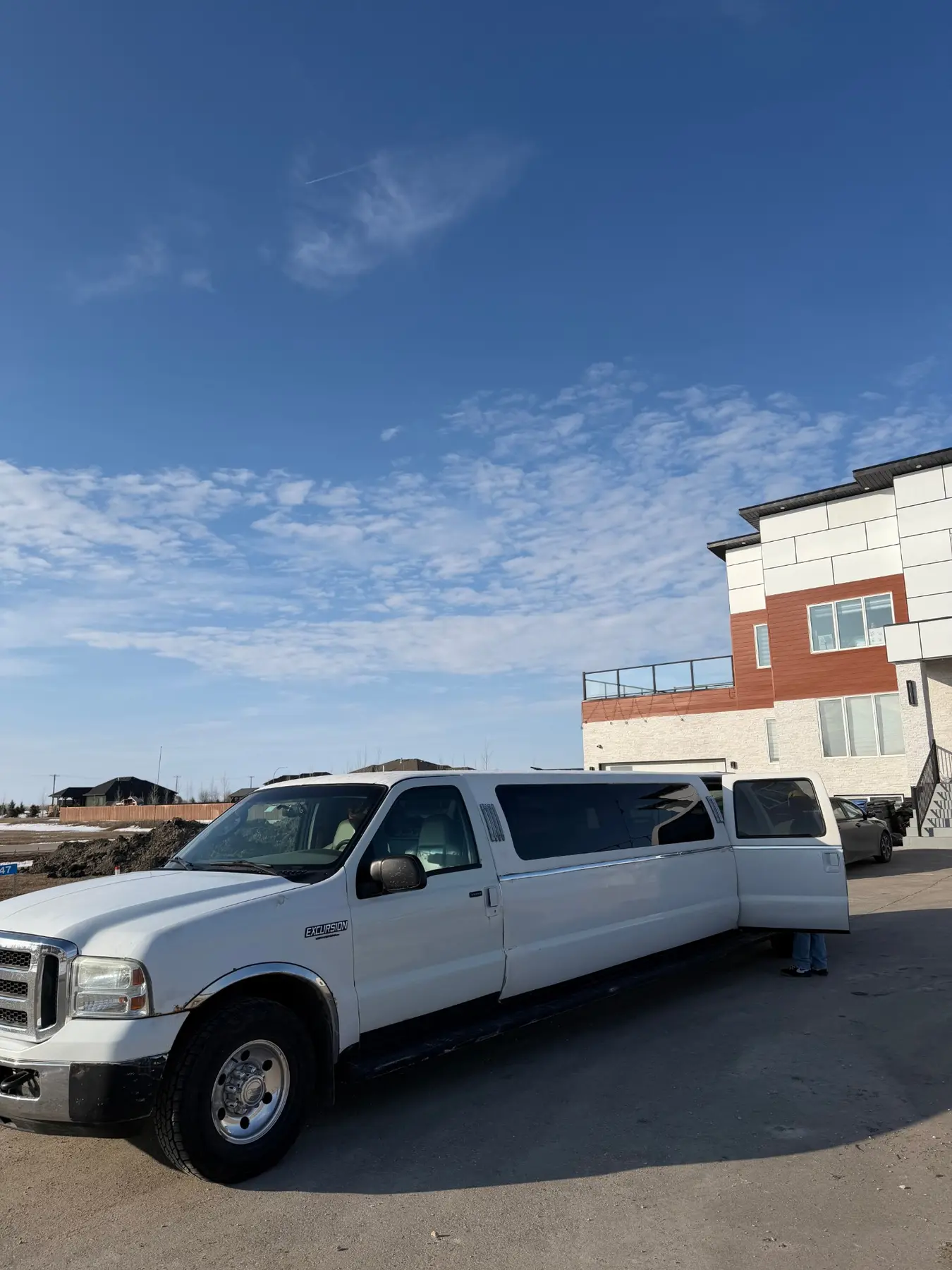 Ford Excursion stretch limousine with the passenger door open