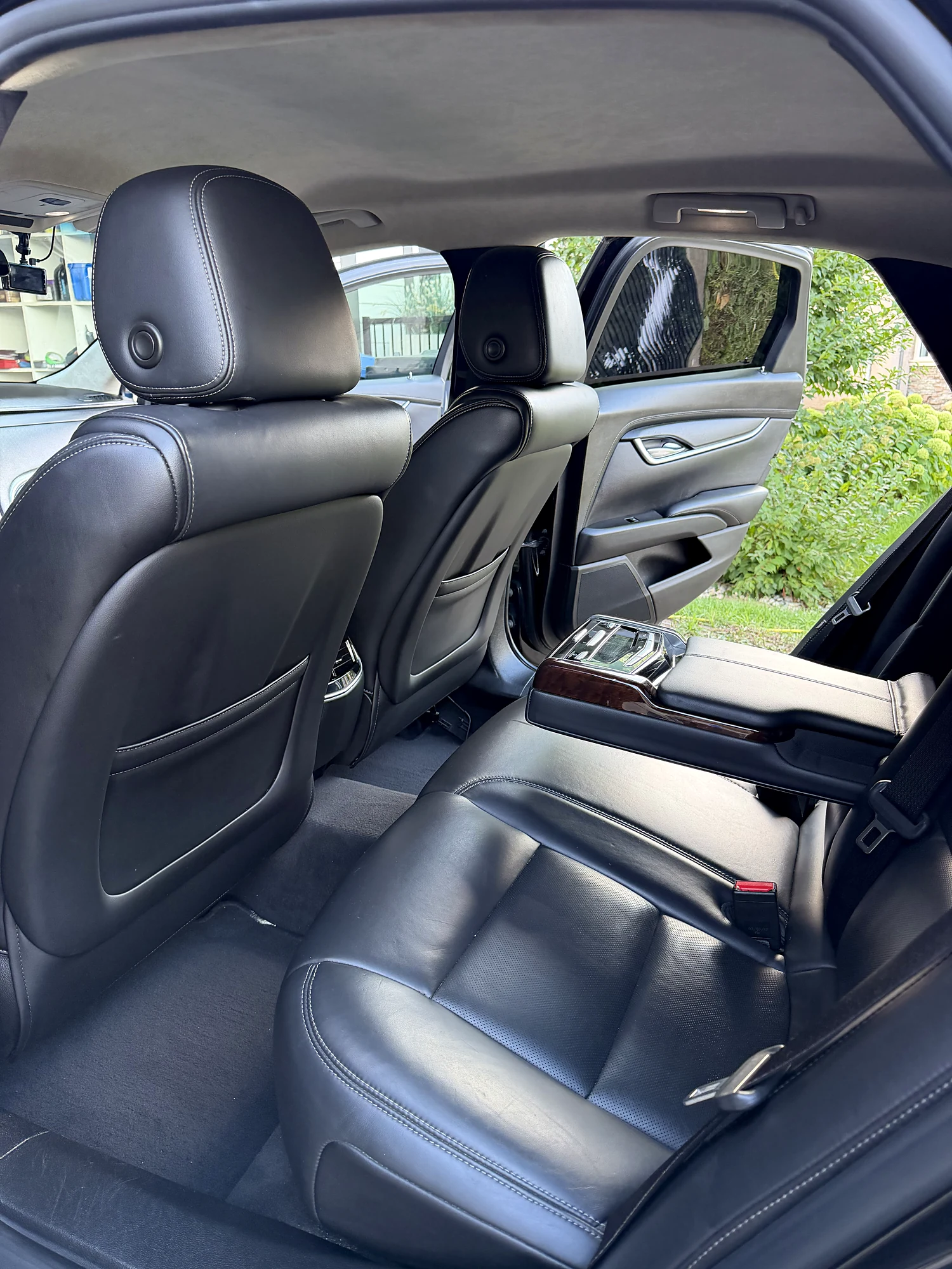 Rear seats of the Cadillac XTS in black leather with the centre armrest down